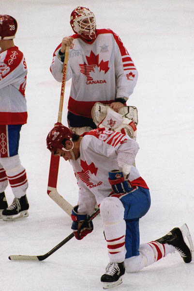 Canada's Sean Burke (goalie) and Eric Lindros shows their disappointment after losing the Gold Medal game against the Unified Team in which Canada won Silver at the 1992 Albertville Olympic winter Games. (CP PHOTO/COA/Scott Grant)