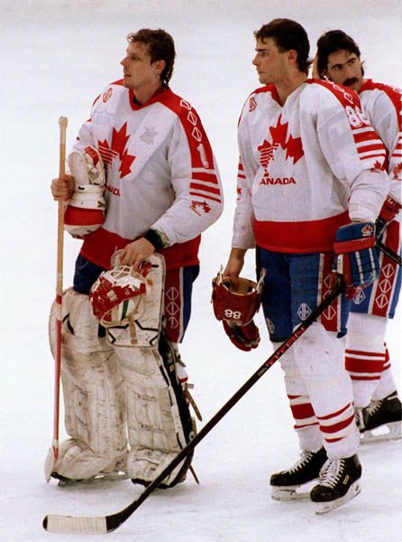 Canada's goalie Sean Burke and  Eric Lindros (centre) after competing in the Gold Medal game against the Unified Team in which Canada won Silver at the 1992 Albertville Olympic winter Games. (CP PHOTO/COA/Scott Grant)