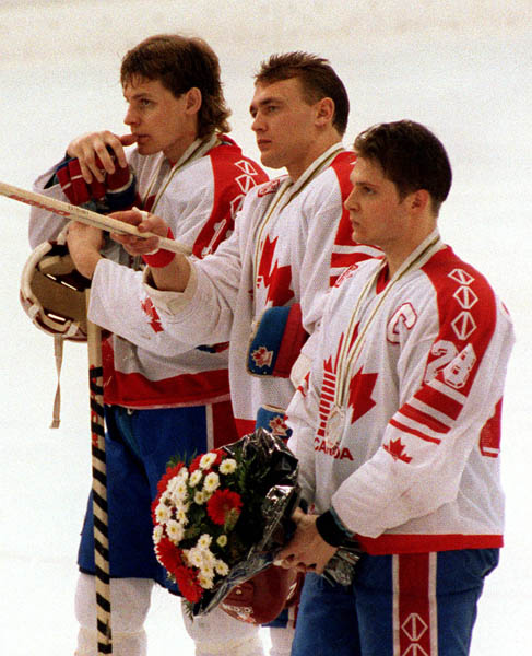 Canada's Brad Schlegel (front), Dan Ratushny (centre) and Chris Lindberg after competing in the Gold Medal game against the Unified Team in which Canada won Silver at the 1992 Albertville Olympic winter Games. (CP PHOTO/COA/Scott Grant)