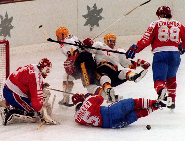 Canada's Sean Burke (goalie), Jason Wooley and Eric Lindros competing in the hockey event against Germany at the 1992 Albertville Olympic winter Games. (CP PHOTO/COA/Scott Grant)