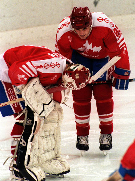 Canada's Sean Burke (goalie) and Eric Lindros (right)  competing in the hockey event against Germany at the 1992 Albertville Olympic winter Games. (CP PHOTO/COA/Scott Grant)