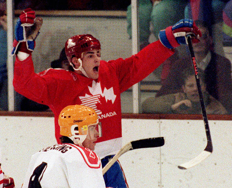 Canada's Eric Lindros (red & blue) competing in the hockey event against Germany at the 1992 Albertville Olympic winter Games. (CP PHOTO/COA/Scott Grant)
