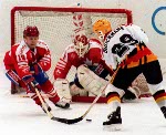 Canada's Sean Burke (goalie), Serge Roy (#3) and Trent Yawney (#5) participate in the hockey event at the 1988 Winter Olympics in Calgary. (CP PHOTO/ COA/ S.Grant)