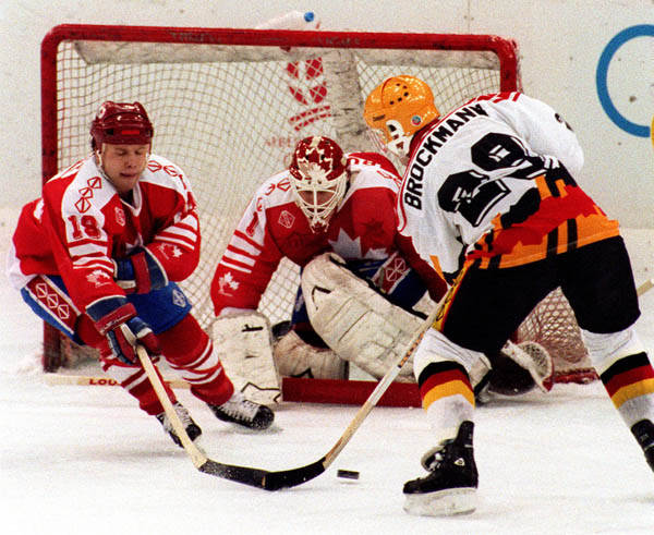 Canada's Kent Manderville (left) and Sean Burke (goalie) competing in the hockey event against Germany at the 1992 Albertville Olympic winter Games. (CP PHOTO/COA/Scott Grant)