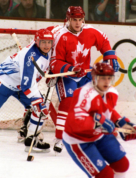 Canada's Kevin Dahl (back right) and Fabian Joseph (foreground) competing in the hockey event against France at the 1992 Albertville Olympic winter Games. (CP PHOTO/COA/Scott Grant)