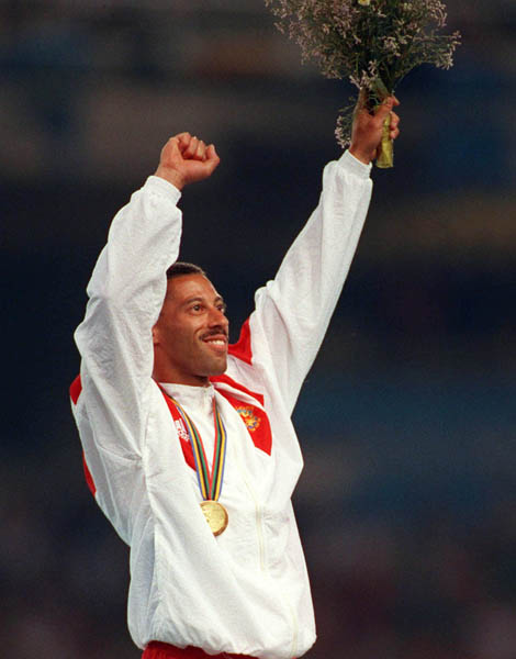 Canada's Mark McKoy celebrates his gold medal win in the 110m hurdles event at the 1992 Barcelona Olympic Games. (CP PHOTO/COA/Claus ANdersen)