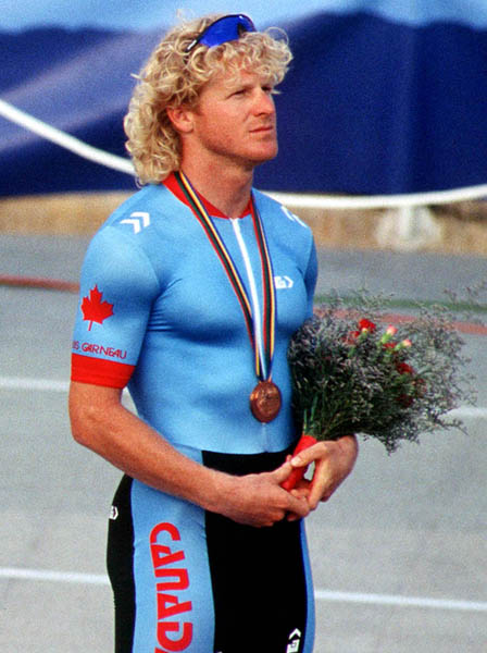 Canada's Curt Harnett stands on the podium with the bronze medal he won in the track event at the 1992 Olympic games in Barcelona. (CP PHOTO/ COA/ Claus Andersen)