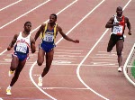 Canada's Ben Johnson (centre) celebrates his gold medal win in the 100m race along with silver medal winner American Carl Lewis (left) and bronze medal winner Britain's Linford Christie at the 1988 Olympic games in Seoul. (CP PHOTO/COA/ Cromby McNeil)