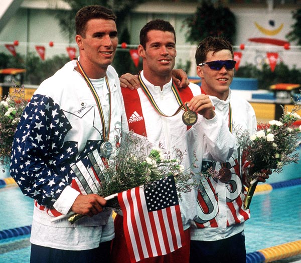 Canada's Mark Tewksbury (centre) and Americans Jeff Rouse (left) and David Berkoff celebrate their medals the won in the swimming event at the 1992 Olympic games in Barcelona. (CP PHOTO/ COA/Ted Grant)
