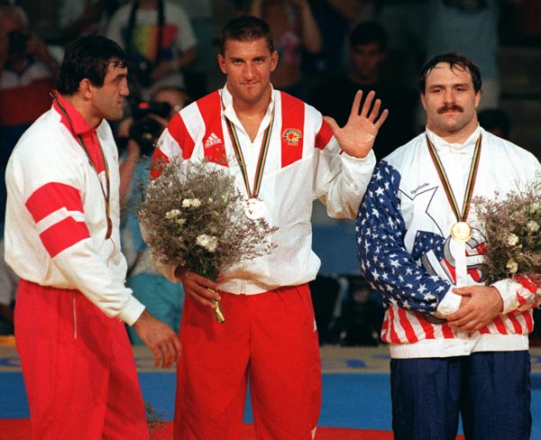 Canada's Jeff Thue (centre) celebrates the silver medal he won in the wrestling event at the 1992 Olympic games in Barcelona. (CP PHOTO/ COA/ Ted Grant)