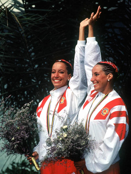 Canada's Penny and Vicky Vilagos, identical twins, celebrate their silver medal win in the synchronized swimming event at the 1992 Olympic games in Barcelona. (CP PHOTO/ COA/ Ted Grant)