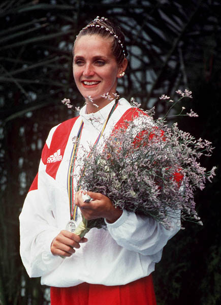 Canada's Sylvie Frchette celebrates the silver medal she won in the synchronized swimming event at the 1992 Olympic games in Barcelona. Due to a judging error at the games, Sylvie was later awarded the gold medal (CP PHOTO/ COA/ Ted Grant)