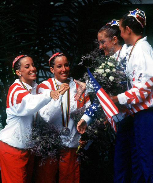 Canada's Penny and Vicky Vilagos (silver) and U.S.A's Karen and Sarah Josephson (gold), identical twins, celebrate their medal wins in the synchronized swimming event at the 1992 Olympic games in Barcelona. (CP PHOTO/ COA/ Ted Grant)
