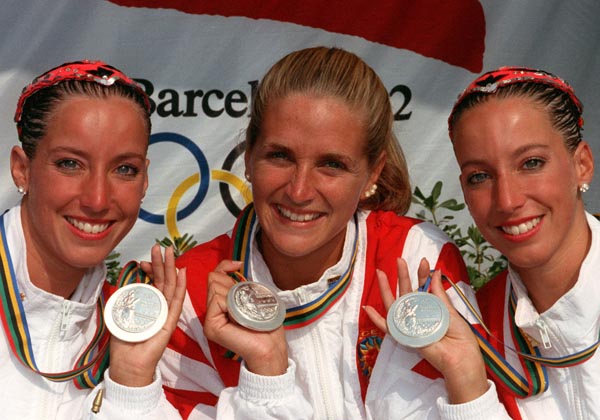 Canada's Penny and Vicky Vilagos, identical twins, and Sylvie Frchette (centre) celebrate their silver medal wins in the synchronized swimming events at the 1992 Olympic games in Barcelona. (CP PHOTO/ COA/ Ted Grant)