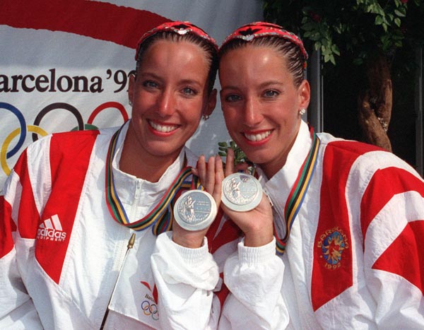 Canada's Penny and Vicky Vilagos, identical twins, celebrate their silver medal win in the synchronized swimming event at the 1992 Olympic games in Barcelona. (CP PHOTO/ COA/ Ted Grant)