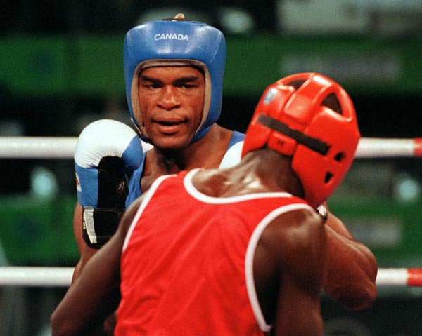 Canada's Chris Johnson (blue) competing in the boxing event at the 1992 Olympic games in Barcelona. (CP PHOTO/ COA/ F.S.Grant)