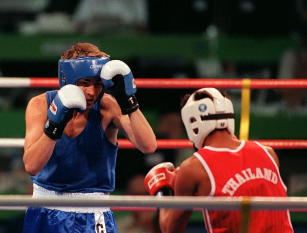 Canada's Mike Strange (blue) competing in the boxing event at the 1992 Olympic games in Barcelona. (CP PHOTO/ COA/ F.S.Grant)