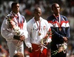 Canada's Ben Johnson (centre) celebrates his gold medal win in the 100m race along with silver medal winner American Carl Lewis (left) and bronze medal winner Britain's Linford Christie at the 1988 Olympic games in Seoul. (CP PHOTO/COA/ Cromby McNeil)