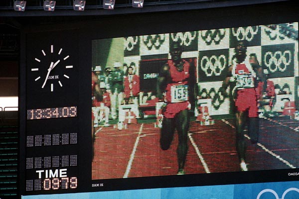 Canada's Ben Johnson is seen on the left of the screen competing in the 100m race in which he won a gold medal, his finishing time is displayed on the bottom left corner at the 1988 Olympic games in Seoul. (CP PHOTO/ COA/ Cromby McNeil)