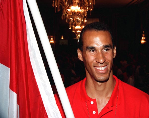 Canada's Michael Smith carries the Canadian Flag during the opening ceremonies at the 1992 Olympic games in Barcelona. (CP PHOTO/ COA/ Claus Andersen)