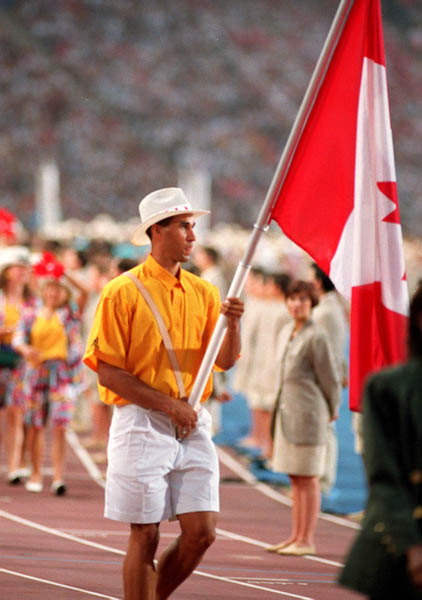 Canada's Michael Smith carries the Canadian Flag during the opening ceremonies at the 1992 Olympic games in Barcelona. (CP PHOTO/ COA/ Claus Andersen)