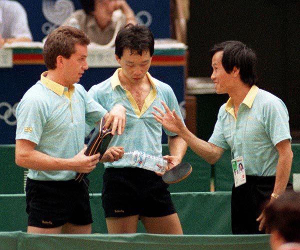 Canada's Joe Ng (centre) and Horatio Pintea (left) with their coach Guoxi Su during the table tennis event at the 1988 Olympic games in Seoul. (CP PHOTO/ COA/ Cromby McNeil)