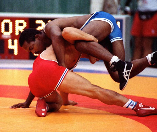 Canada's Gary Holmes (blue) competing in the wrestling event at the 1988 Olympic games in Seoul. (CP PHOTO/ COA/ Cromby McNeil)