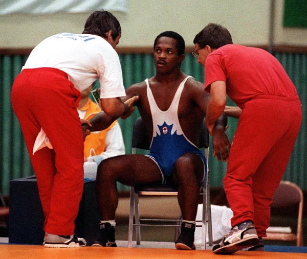 Canada's Gary Holmes and his coaches Jim Miller (left) and Nick Cipriano competing in the wrestling event at the 1988 Olympic games in Seoul. (CP PHOTO/ COA/ Cromby McNeil)