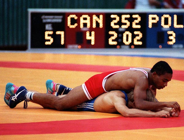 Canada's Lawrence Holmes (red) competing in the wrestling event at the 1988 Olympic games in Seoul. (CP PHOTO/ COA/ Cromby McNeil)