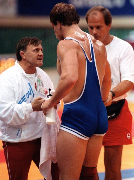 Canada's Steve Marshall (right) and his coach Louis Kupsic competing in the wrestling event at the 1988 Olympic games in Seoul. (CP PHOTO/ COA/ Cromby McNeil)