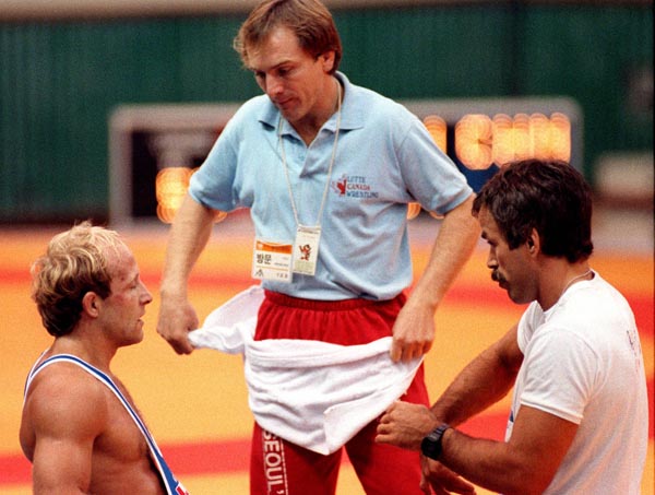 Canada's David McKay (left) with coaches Gary Gardner (centre) and Jim Miller competing in the wrestling event at the 1988 Olympic games in Seoul. (CP PHOTO/ COA/ Cromby McNeil)