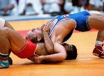 Canada's David McKay (blue) competing in the wrestling event at the 1988 Olympic games in Seoul. (CP PHOTO/ COA/ Cromby McNeil)