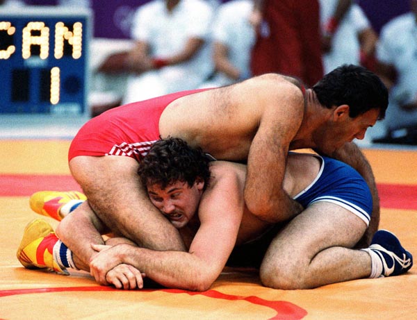 Canada's Dan Payne (blue) competing in the wrestling event at the 1988 Olympic games in Seoul. (CP PHOTO/ COA/ Cromby McNeil)