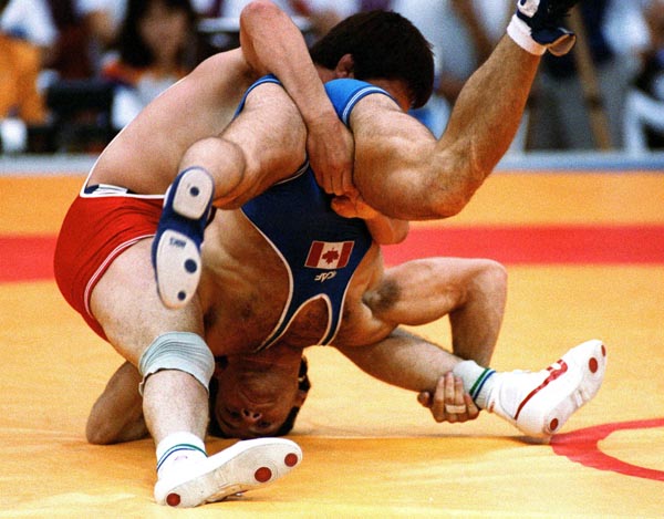 Canada's Chris Rinke (blue) competing in the wrestling event at the 1988 Olympic games in Seoul. (CP PHOTO/ COA/ Cromby McNeil)