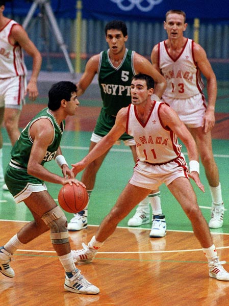 Canada's John Hatch (#11) and Romel Raffin (#13) competing in the basketball event at the 1988 Olympic games in Seoul. (CP PHOTO/ COA/ F. Scott Grant)