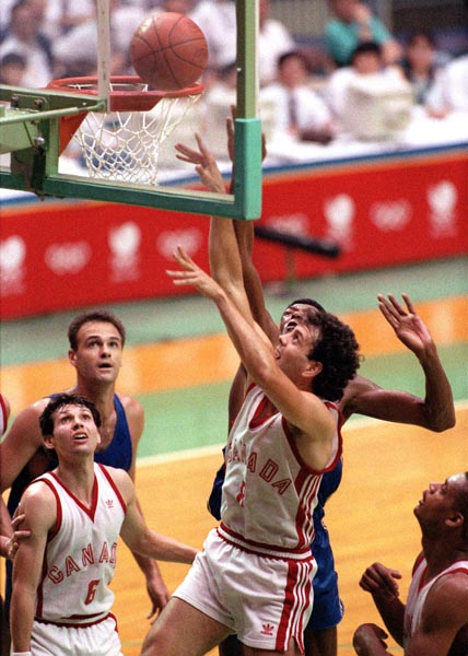 Canada's Alan Kristmanson (centre) and Eli Pasquale (left) competing in the basketball event at the 1988 Olympic games in Seoul. (CP PHOTO/ COA/ F. Scott Grant)