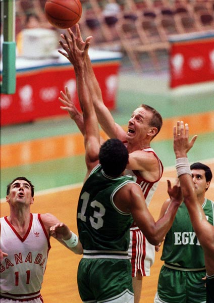Canada's John Hatch (left) and Romel Raffin (centre) competing in the basketball event at the 1988 Olympic games in Seoul. (CP PHOTO/ COA/ F. Scott Grant)