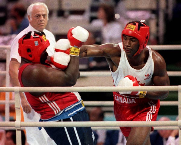 Canada's Lennox Lewis (right) competing in the boxing event at the 1988 Olympic games in Seoul. (CP PHOTO/ COA/ S.Grant)
