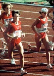 Canada's Lizanne Bussieres (right) and Nancy Ditz of the U.S.A help Misako Miyashara of Japan to her feet during the marathon event at the 1988 Olympic games in Seoul. (CP PHOTO/ COA/F.S.Grant)