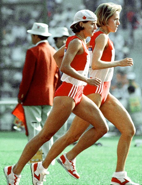 Canada's Lizanne Bussieres (hat) and Ellen Rochefort competing in the marathon event at the 1988 Olympic games in Seoul. (CP PHOTO/ COA/F.S.Grant)