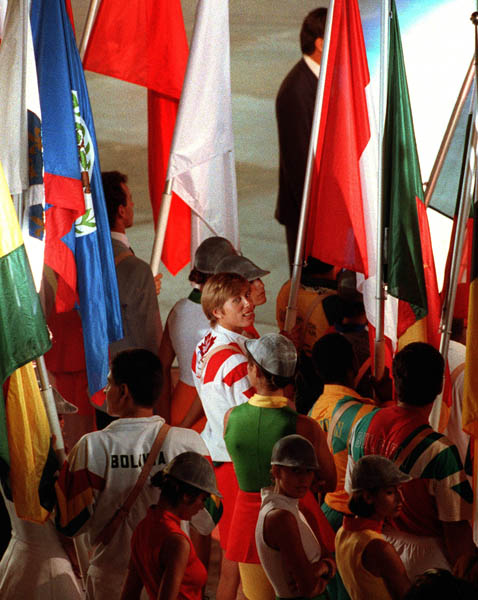 Canada's Silken Laumann (white and red) carries the Canadian Flag during the closing ceremonies at the 1992 Olympic games in Barcelona. (CP PHOTO/ COA/ Claus Andersen)