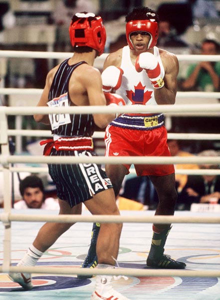 Canada's Ray Downey (right) in action against his opponent Si-Hun Park from Korea at the 1988 Olympic Games in Seoul. (CP Photo/ COA/F.S.Grant)