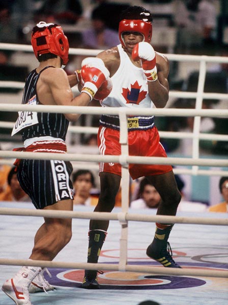 Canada's Ray Downey (right) in action against his opponent Si-Hun Park from Korea at the 1988 Olympic Games in Seoul. (CP Photo/ COA/F.S.Grant)