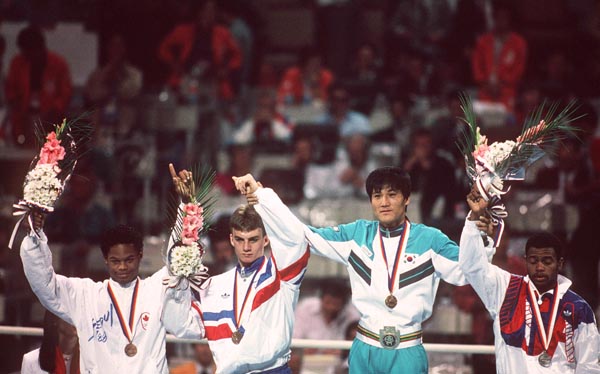 Canada's Ray Downey (left) celebrates after winning the bronze medal in the boxing event at the 1988 Olympic Games in Seoul. (CP Photo/ COA/S.Grant)
