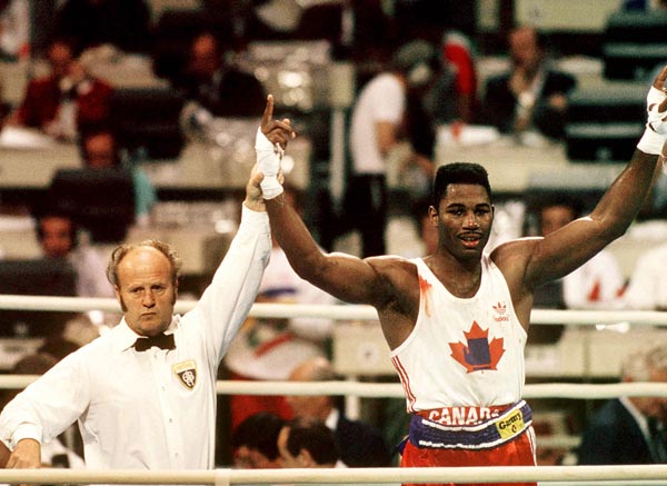 Canada's Lennox Lewis celebrates after winning the gold medal in boxing at the 1988 Olympic Games in Seoul. (CP Photo/ COA/S.Grant)