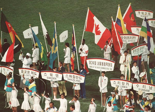 Canada's Lennox Lewis carries the Canadian flag at the 1988 Olympic games in Seoul. (CP PHOTO/ COA/ Cromby McNeil)