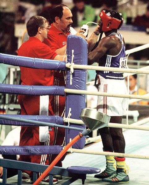 Canada's Egerton Marcus (right) with his coach Adrian Teodorescu (centre) competing in the boxing event at the 1988 Olympic games in Seoul. (CP PHOTO/ COA/ S.Grant)