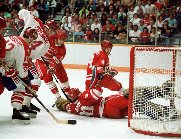 Canada's Serge Boisvert (#12) and Jim Peplinski (#24) participate in the hockey event at the 1988 Winter Olympics in Calgary. (CP PHOTO/COA/S.Grant)