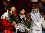 Canada's Sylvie Daigle (left) celebrates her silver medal win in the speedskating event with gold medal winner Yan Li (centre) of China and bronze medal winner Monique Velzeboer (right) of the Netherlands at the 1988 Winter Olympics in Calgary. (CP PHOTO/