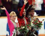 Canada's Elizabeth Manley (left) celebrates her silver medal win in the figure skating event along with gold medalist Katarina Witt (centre) of East Germany and Bronze medalist Debi Thomas of the U.S.A. at the 1988 Winter Olympics in Calgary. (CP PHOTO/CO